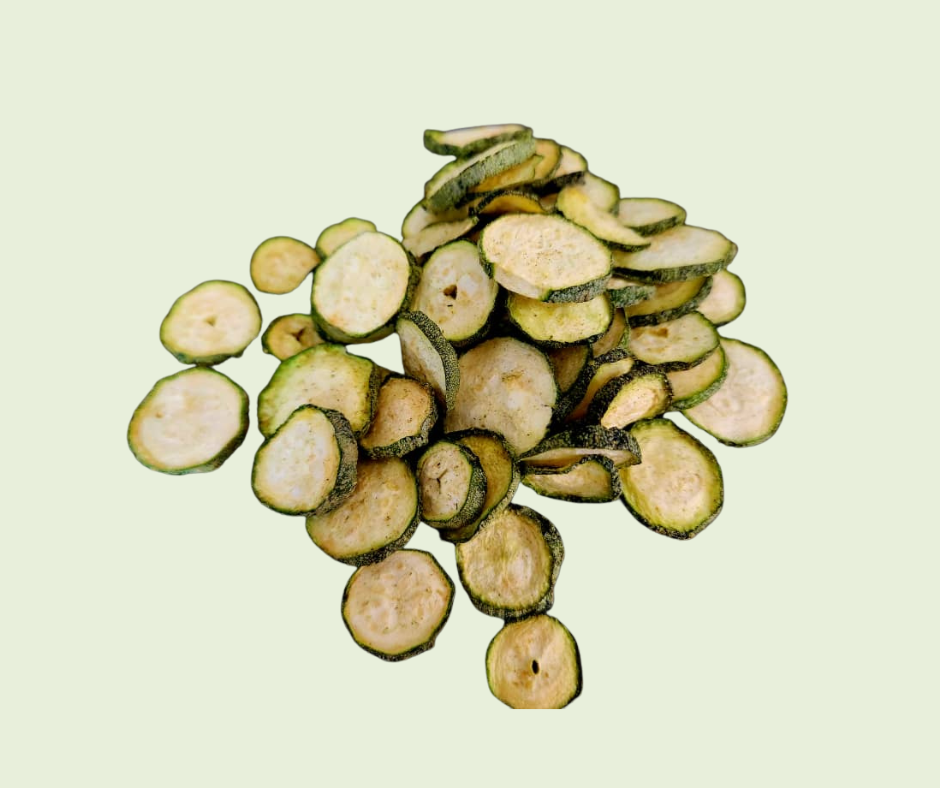 Sliced zucchini pieces on a light green background